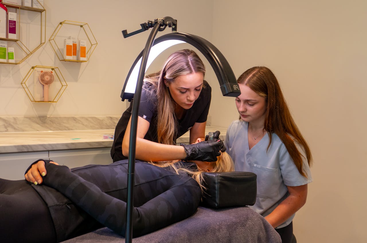 journey-01 Women performing a cosmetic procedure in a modern dermatology clinic. Focus on precision and care.