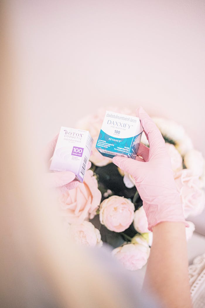 Elegant skincare product display with pink roses and gloves in a modern spa.